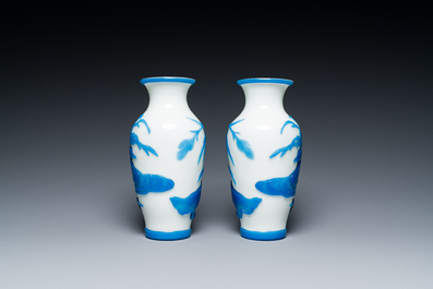 A pair of Chinese blue-overlay white Beijing glass vases with mandarin ducks and a orange-overlay white bottle vase, 19/20th C.