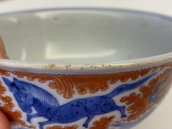 A Chinese famille rose bowl, a 'peaches' plate, a blue and white and iron-red bowl and a 'phoenix' plate, Wanli and Jiaqing marks, 19th C.