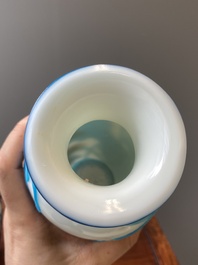 A pair of Chinese blue-overlay white Beijing glass vases with mandarin ducks and a orange-overlay white bottle vase, 19/20th C.