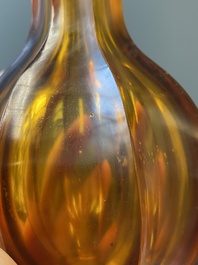 A Chinese facetted translucent amber-coloured Peking glass bottle vase, Qianlong mark, 19th C.