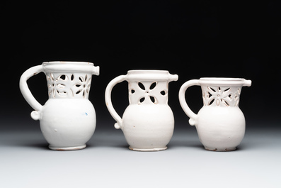 Three French white-glazed and two polychrome puzzle jugs, Nevers, 18th C.