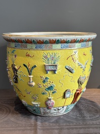 A Chinese famille rose yellow-ground relief-molded 'antiquities' fish bowl, Zhengde mark, 19th C.