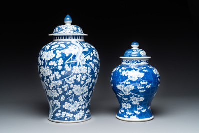 Two Chinese blue and white 'prunus on cracked ice' vases and covers, Kangxi mark, 19th C.