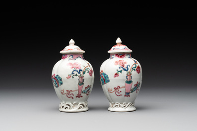 A pair of Chinese famille rose 'antiquities' tea caddies and covers, Yongzheng/Qianlong