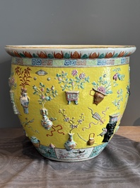 A Chinese famille rose yellow-ground relief-molded 'antiquities' fish bowl, Zhengde mark, 19th C.