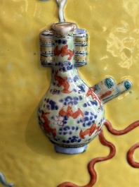 A Chinese famille rose yellow-ground relief-molded 'antiquities' fish bowl, Zhengde mark, 19th C.