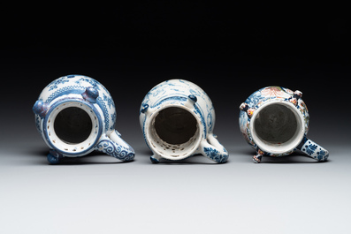 Two blue and white and one polychrome Dutch Delft puzzle jugs, dated 1734 and 1705, 18th C. and later