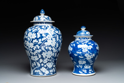 Two Chinese blue and white 'prunus on cracked ice' vases and covers, Kangxi mark, 19th C.