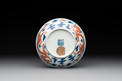 An imperial Chinese blue, white and iron-red 'dragon' plate, Qianlong mark and of the period