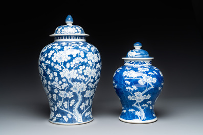 Two Chinese blue and white 'prunus on cracked ice' vases and covers, Kangxi mark, 19th C.