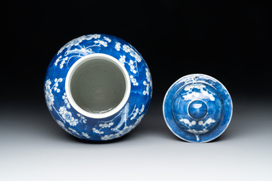 Two Chinese blue and white 'prunus on cracked ice' vases and covers, Kangxi mark, 19th C.