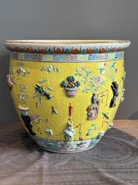 A Chinese famille rose yellow-ground relief-molded 'antiquities' fish bowl, Zhengde mark, 19th C.