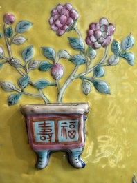 A Chinese famille rose yellow-ground relief-molded 'antiquities' fish bowl, Zhengde mark, 19th C.
