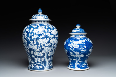 Two Chinese blue and white 'prunus on cracked ice' vases and covers, Kangxi mark, 19th C.
