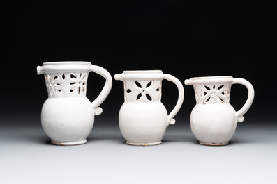 Three French white-glazed and two polychrome puzzle jugs, Nevers, 18th C.