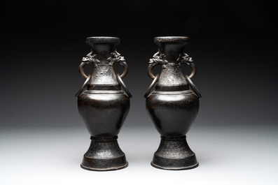 A pair of Chinese bronze vases with 'dragon' handles, Yuan/Ming