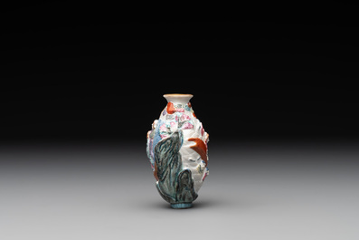 A Chinese famille rose molded 'capsized boat' snuff bottle, Qianlong mark, 19th C.