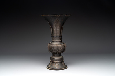 A Chinese archaistic bronze 'gu' vase with relief design, Ming
