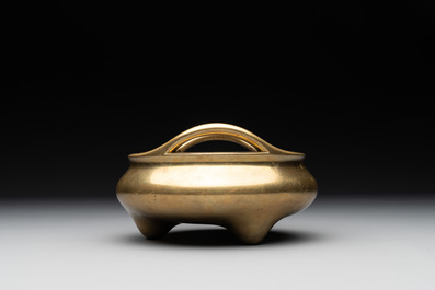 A Chinese bronze tripod censer on a wooden stand, Song Zhu Xuan 松竹軒 mark, 18th C.