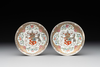 A fine Chinese famille rose armorial cup and two saucers, Yongzheng/Qianlong