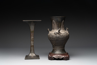 A Chinese archaistic bronze 'gu' vase and a 'hu' vase with rams in relief on a wooden stand, 18/19th C.