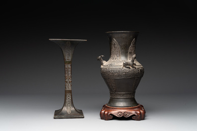 A Chinese archaistic bronze 'gu' vase and a 'hu' vase with rams in relief on a wooden stand, 18/19th C.