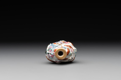 A Chinese famille rose molded 'capsized boat' snuff bottle, Qianlong mark, 19th C.