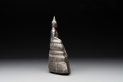 A Cambodian silver repouss&eacute; Buddha with inscription, 19th C.