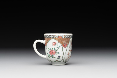 A fine Chinese famille rose armorial cup and two saucers, Yongzheng/Qianlong