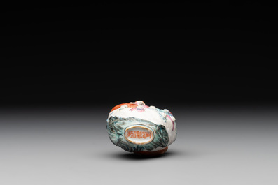 A Chinese famille rose molded 'capsized boat' snuff bottle, Qianlong mark, 19th C.