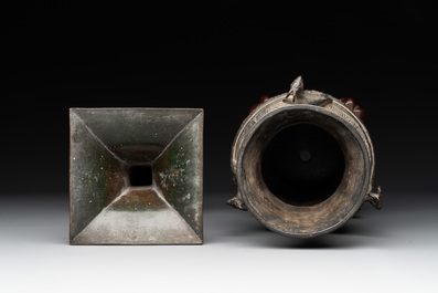 A Chinese archaistic bronze 'gu' vase and a 'hu' vase with rams in relief on a wooden stand, 18/19th C.