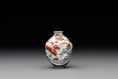 A Chinese famille rose molded 'capsized boat' snuff bottle, Qianlong mark, 19th C.