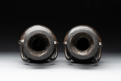 A pair of Chinese bronze vases with 'dragon' handles, Yuan/Ming