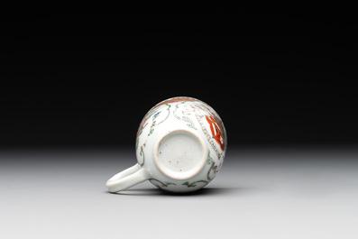 A fine Chinese famille rose armorial cup and two saucers, Yongzheng/Qianlong