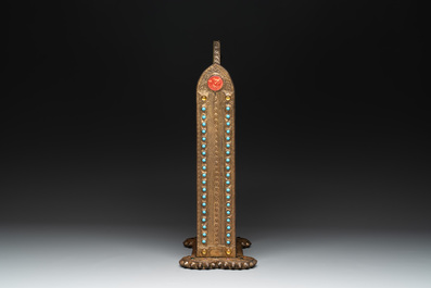 Alfred Daguet (Paris, 1875-1942): A Gothic Revival repouss&eacute; brass and copper-mounted mirror with glass cabochons, signed and dated 1907