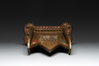Alfred Daguet (Paris, 1875-1942): A Gothic Revival repouss&eacute; brass and copper-mounted mirror with glass cabochons, signed and dated 1907