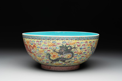A Chinese famille rose turquoise-and-yellow-ground 'dragon' bowl on wooden stand, Qianlong mark, Republic