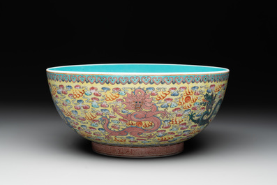 A Chinese famille rose turquoise-and-yellow-ground 'dragon' bowl on wooden stand, Qianlong mark, Republic