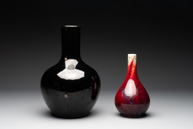 A Chinese black-glazed 'tianqiu ping' vase and a flamb&eacute;-glazed bottle vase, 19/20th C.
