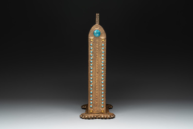 Alfred Daguet (Paris, 1875-1942): A Gothic Revival repouss&eacute; brass and copper-mounted mirror with glass cabochons, signed and dated 1907