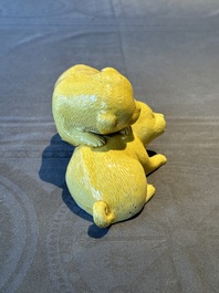 A Japanese monochrome yellow-glazed 'two playing dogs' group, 19th C.