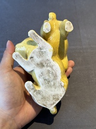 A Japanese monochrome yellow-glazed 'two playing dogs' group, 19th C.