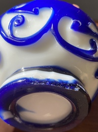A pair of Chinese blue-overlay white Beijing glass 'chilong' bottle vases, 19th C.