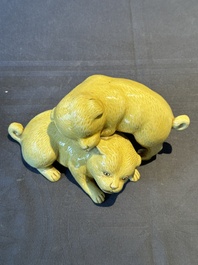 A Japanese monochrome yellow-glazed 'two playing dogs' group, 19th C.