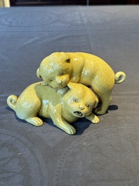 A Japanese monochrome yellow-glazed 'two playing dogs' group, 19th C.