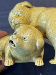 A Japanese monochrome yellow-glazed 'two playing dogs' group, 19th C.