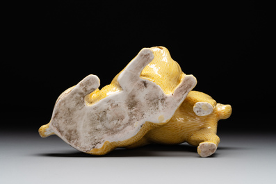A Japanese monochrome yellow-glazed 'two playing dogs' group, 19th C.