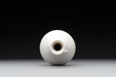 A small Chinese Dehua blanc de Chine 'dragon' bottle vase, Kangxi