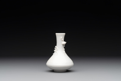 A small Chinese Dehua blanc de Chine 'dragon' bottle vase, Kangxi