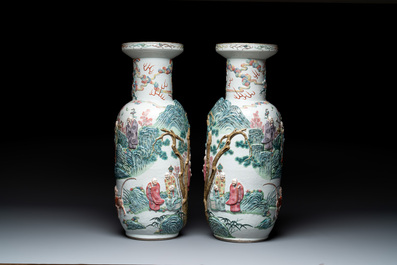 A pair of Chinese famille rose '18 luohan' vases with relief design, 19th C.